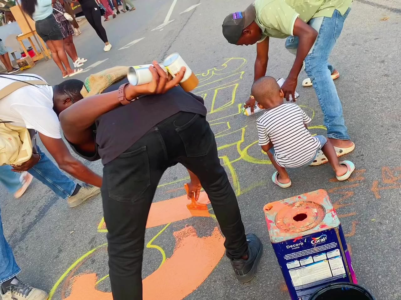 Community members painting a public street mural